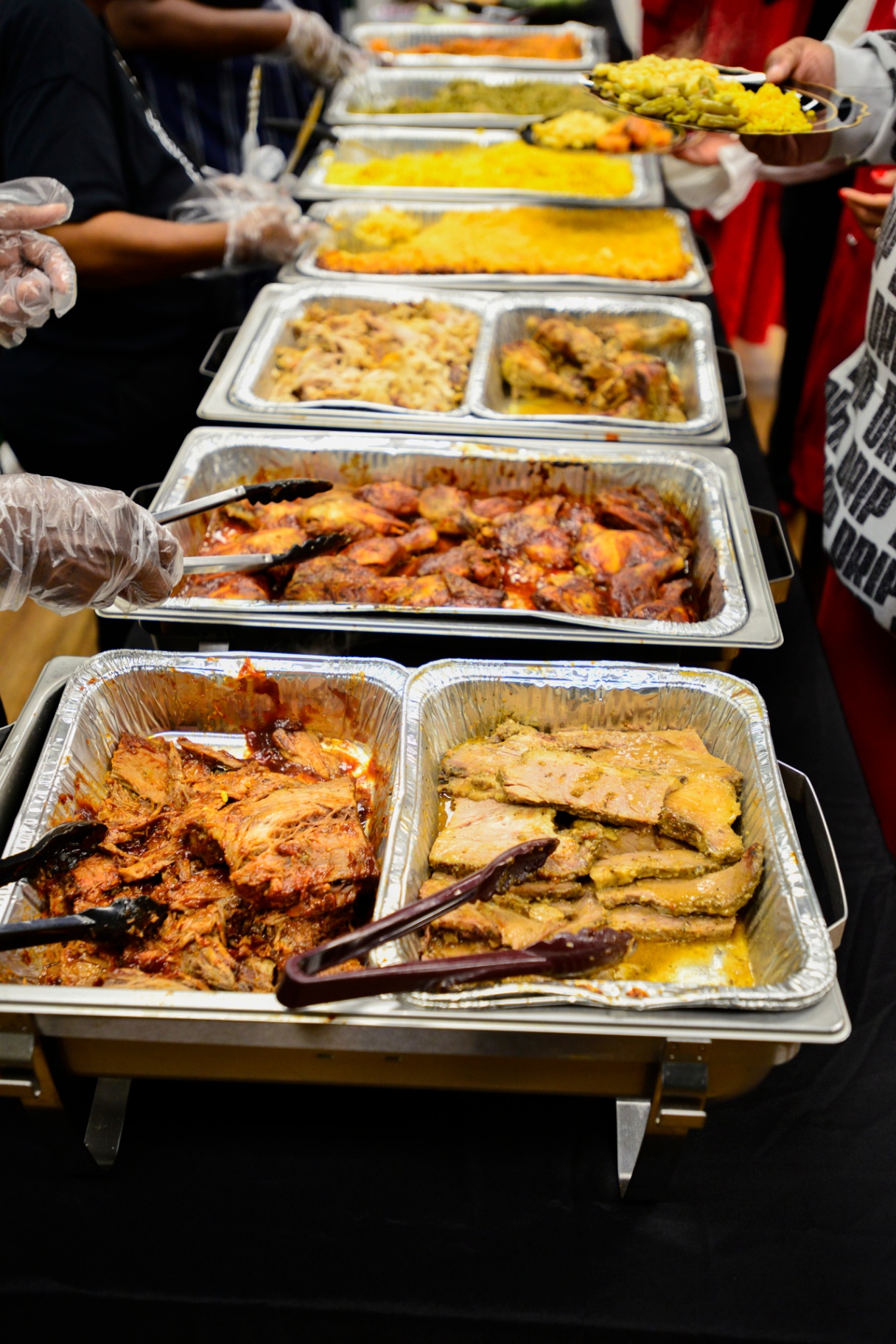 Catered buffet line with trays of food